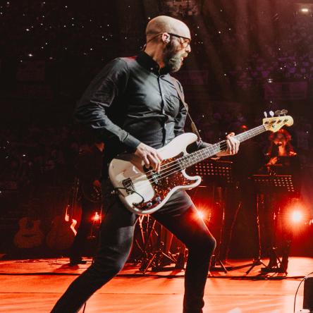 Carl plays the bass guitar