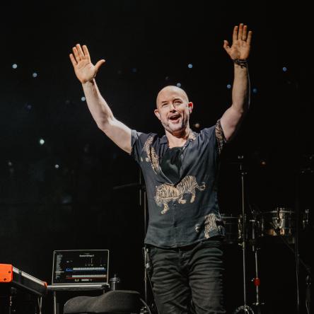 Tim with his arms in the air